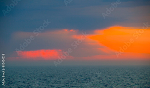 Ocean views from open deck of luxury oceanliner or cruiseship or cruise ship liner at sea cruising with horizon and blue sky during twilight photo