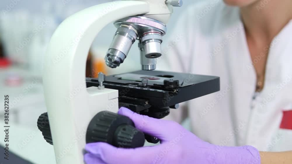 Microbiologist is testing a sample of blood contaminated by Coronavirus Covid-19 Microbiologist is testing a sample of blood contaminated by Coronavirus Covid-19