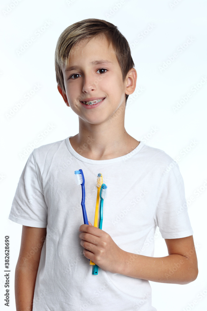 Smiling boy with toothbrush in hand isolated on white background Smiling boy with toothbrush in hand isolated on white background