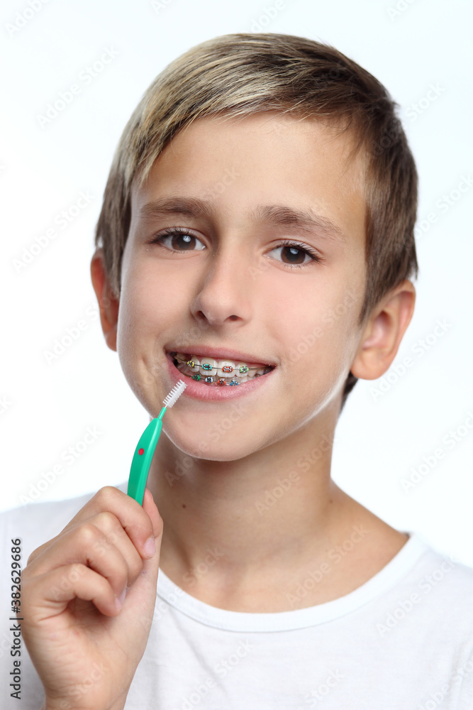 Happy boy cleaning brace by interdental brush Happy boy cleaning brace by interdental brush