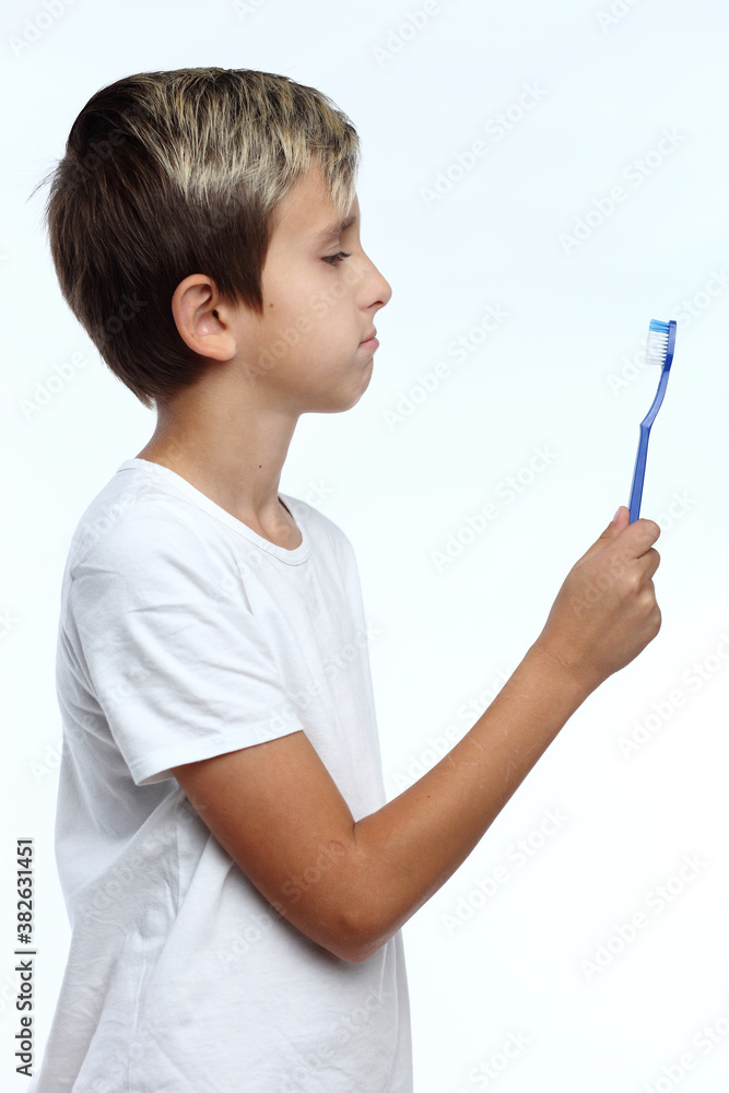 Boyholding a toothbrush isolated on white background Boyholding a toothbrush isolated on white background