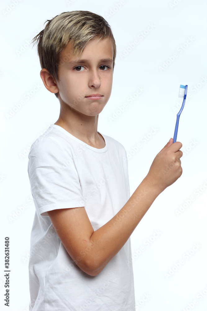 Boyholding a toothbrush isolated on white background Boyholding a toothbrush isolated on white background