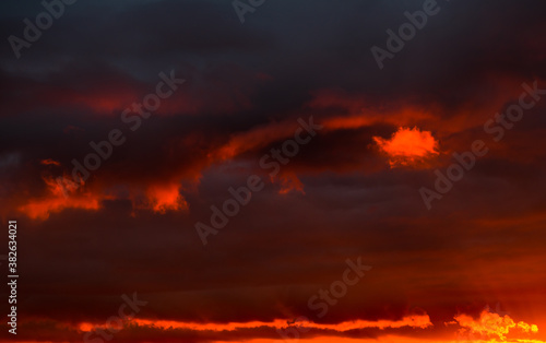 Beautiful sunset. Red and black clouds in the sky