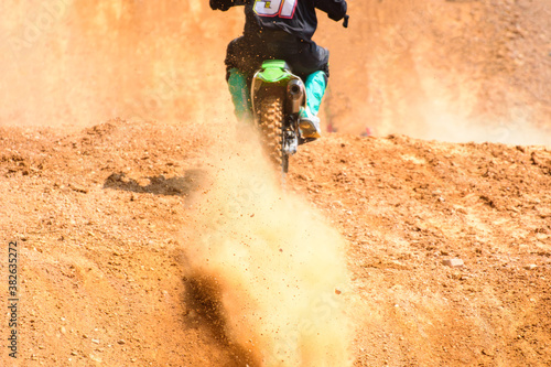 Fototapeta Naklejka Na Ścianę i Meble -  motocross show  racer accelerating in dirt track