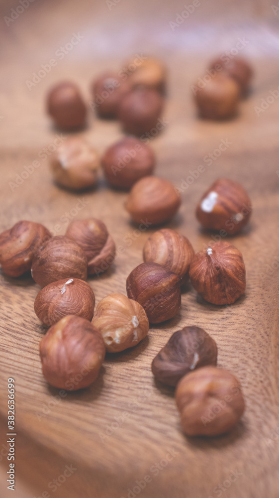 Hazelnuts in a wooden bowl. Autumn background. Hazelnuts in a wooden bowl. Autumn background.