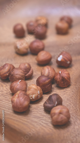 Hazelnuts in a wooden bowl. Autumn background.
