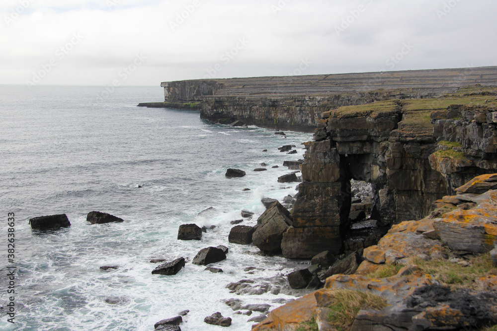 Large cliffs on the coast of Ireland with gray skies