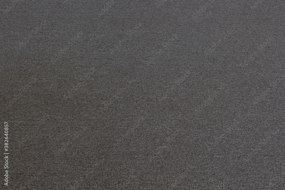 Texture of a woolen gray rug. Texture of a woolen gray rug.