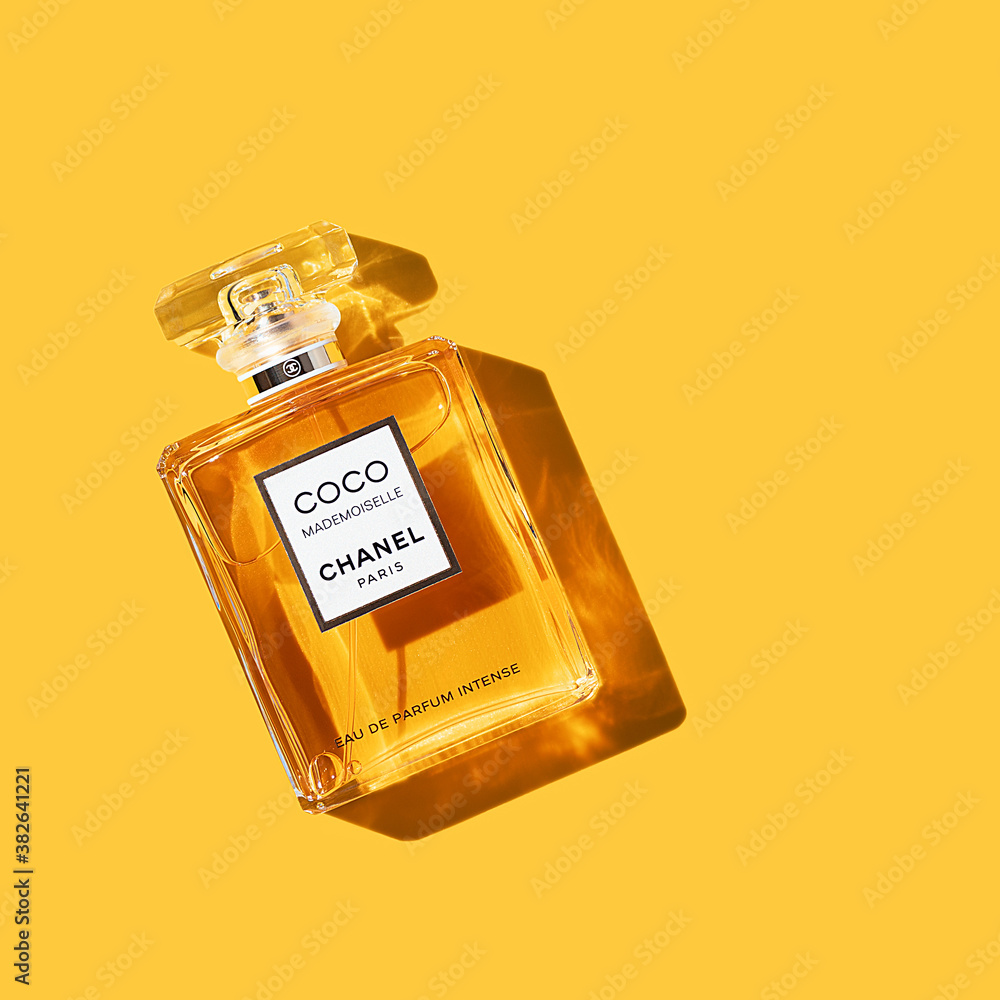 A bottle of Chanel perfume on a uniform yellow background, with a beautiful  shadow with highlights. Coco Chanel woman perfume series. 2020-07-05 Samara.  Stock Photo