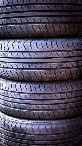 Set of summer car tires isolated. Tire stack background. Car tyre protector close up. Black rubber tire. New car tires. Close up tyre profile. Car tires in a row