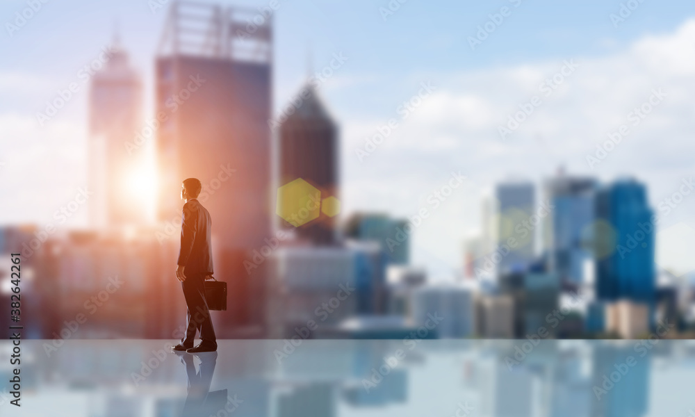 Businessman facing new day Businessman facing new day