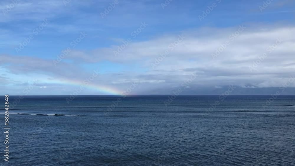Rainbow over the ocean from the coast of Maui Rainbow over the ocean from the coast of Maui