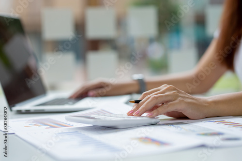 Closeup of business lady working at the table with laptop. Loft office, researching new business strategy. Wide screen panoramic