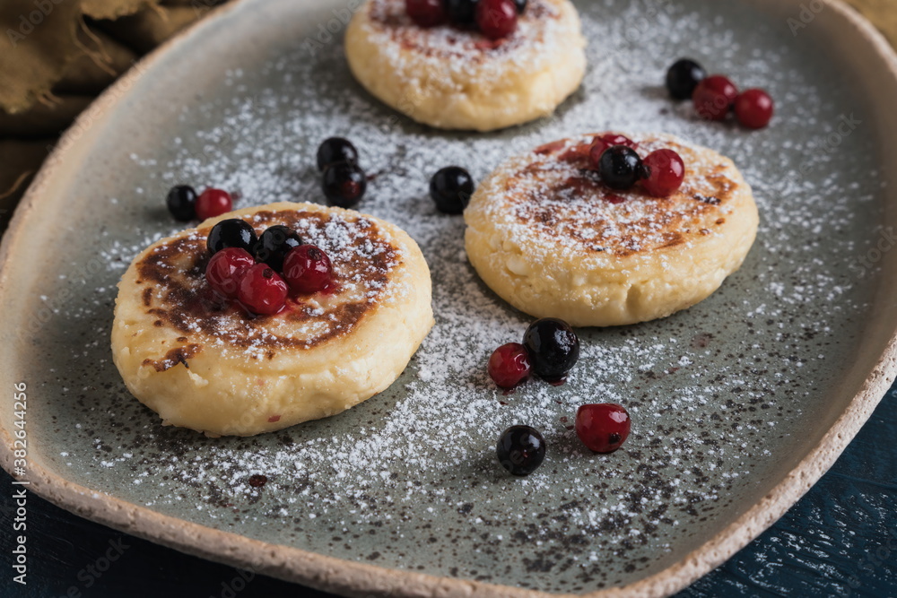 cottage cheese pancakes with wild berries and powdered sugar