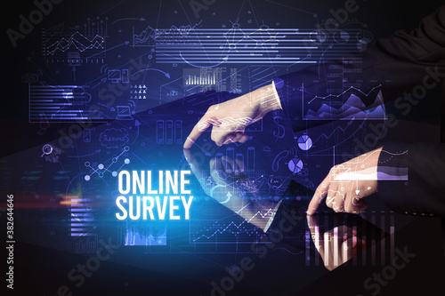 Businessman touching huge screen with ONLINE SURVEY inscription, cyber business concept