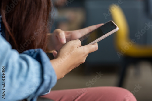Asian young woman using smartphone in coffee shop
