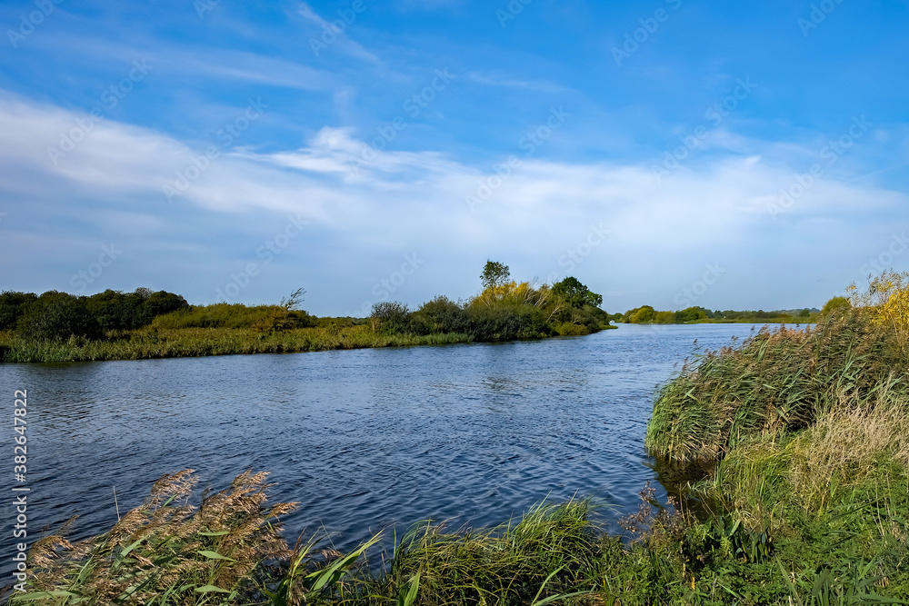 A windy and sunny day on the River Yare in RSPB Strumpshaw Fen Nature Reserve in the Norfolk Broads National Park