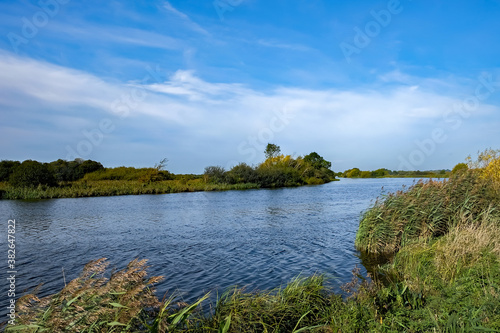 A windy and sunny day on the River Yare in RSPB Strumpshaw Fen Nature Reserve in the Norfolk Broads National Park