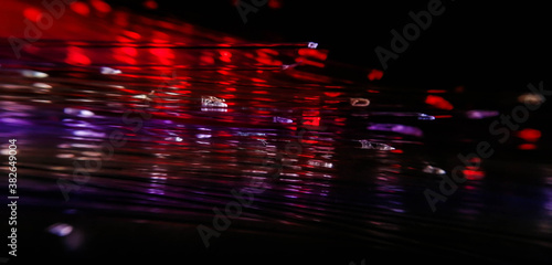 This picture displays colored bottle lights which look like fiber optic cables. The background is black.