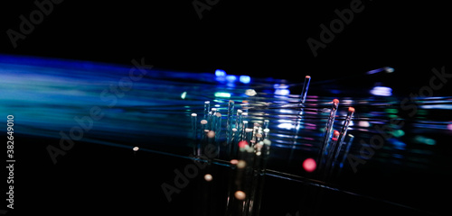 This picture displays colored bottle lights which look like fiber optic cables. The background is black.
