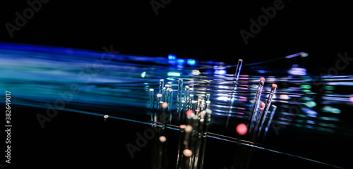 This picture displays colored bottle lights which look like fiber optic cables. The background is black.