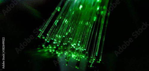 This picture displays colored bottle lights which look like fiber optic cables. The background is black.