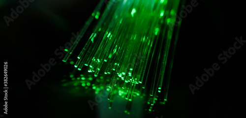 This picture displays colored bottle lights which look like fiber optic cables. The background is black.