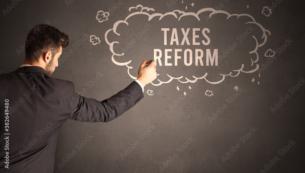 businessman drawing a cloud with TAXES REFORM inscription inside, modern business concept