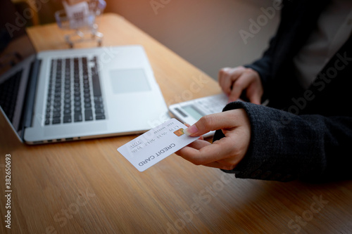 Close up Hands using credit card and smartphones for online shopping and paying via the internet ,Toned picture, e-commerce, SME,internet banking, spending money, working from home concept