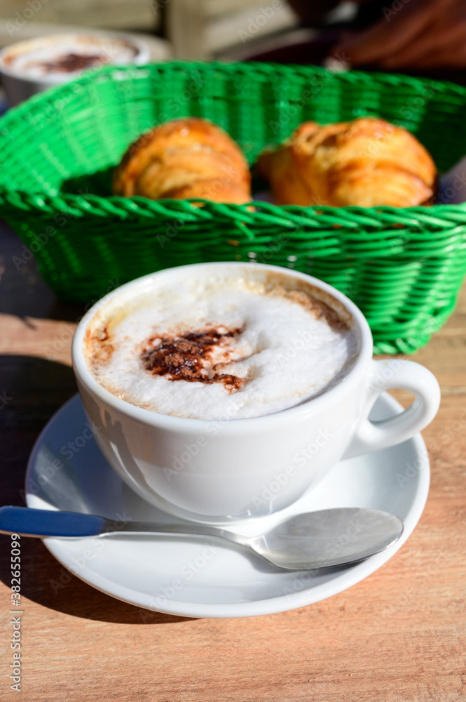 French breakfast in bakery served outdoor, cups of coffee and fresh baked croissants and pastry, morning food French breakfast in bakery served outdoor, cups of coffee and fresh baked croissants and pastry, morning food