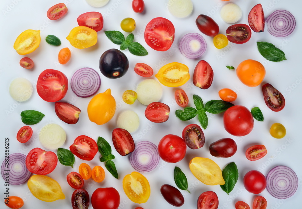 lots of tomatoes, onion slices and basil leaves isolated on a white background lots of tomatoes, onion slices and basil leaves isolated on a white background