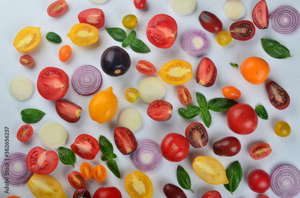 lots of tomatoes, onion slices and basil leaves isolated on a white background lots of tomatoes, onion slices and basil leaves isolated on a white background