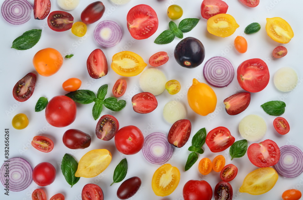 lots of tomatoes, onion slices and basil leaves isolated on a white background lots of tomatoes, onion slices and basil leaves isolated on a white background