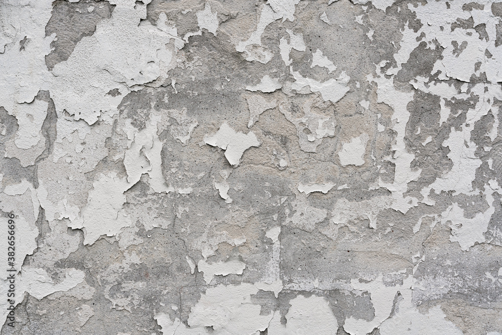 Obraz premium Close up of concrete wall with texture of white paint peeling off
