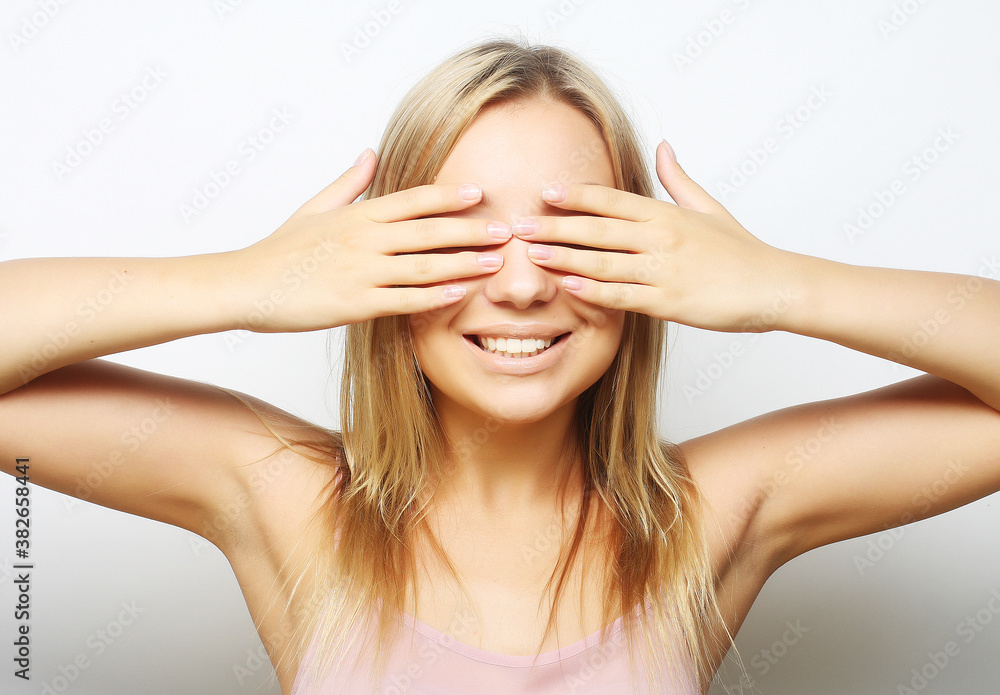 teen girl with her hands covering her eyes. teen girl with her hands covering her eyes.