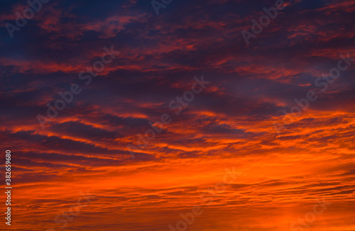Orange clouds in the sunset sky © E.O.