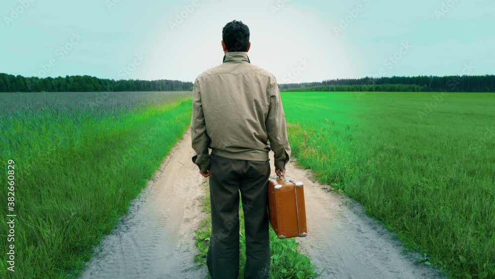 lonely man confused, in doubt, standing beside country road, life way, holding suitcase, decision cross roads, travel concept