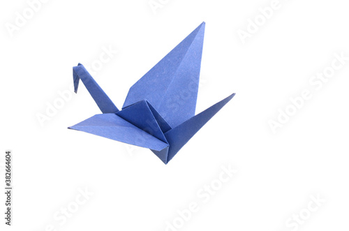 Blue origami bird on white background