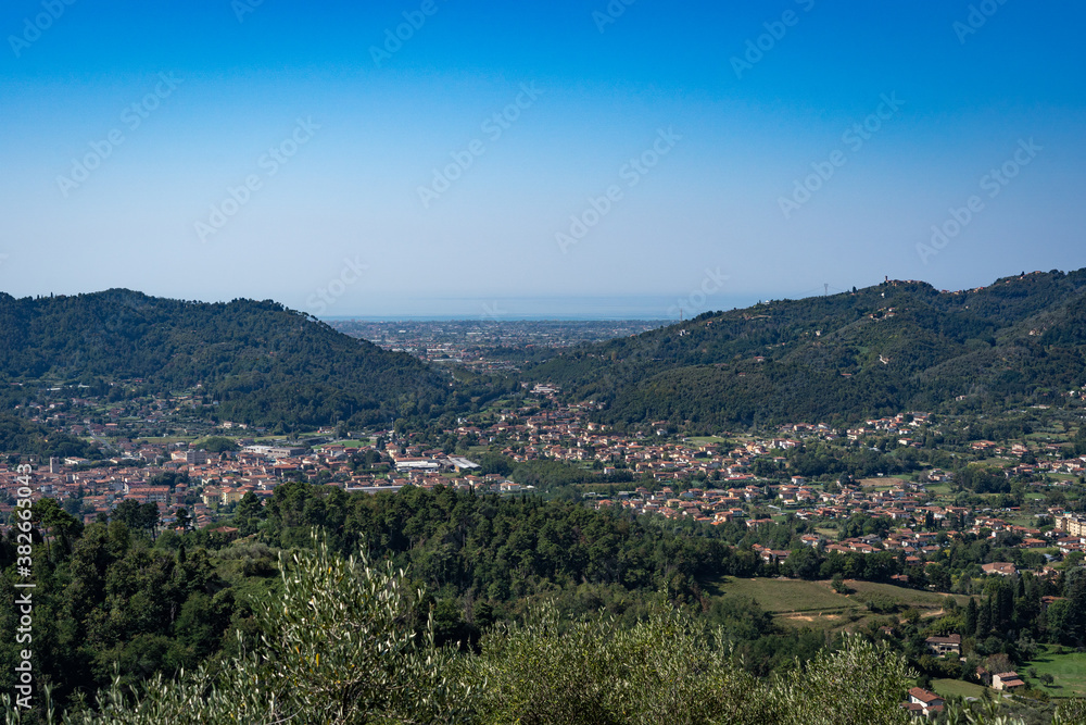Italian landscape view from Montecastrese, Camaiore to Viareggio, with mountains blue sky and sea