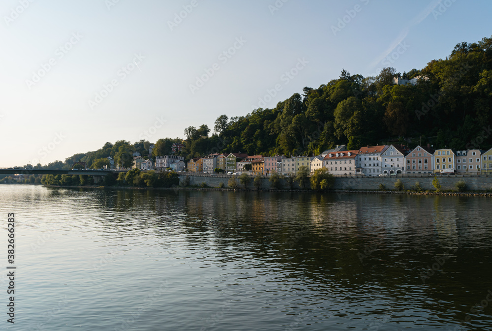 Panoramic view of houses reflecting on the Danube River in summer, Passau, Germany