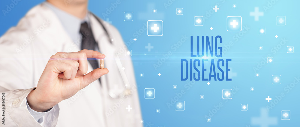 Close-up of a doctor giving a pill with LUNG DISEASE inscription, medical concept