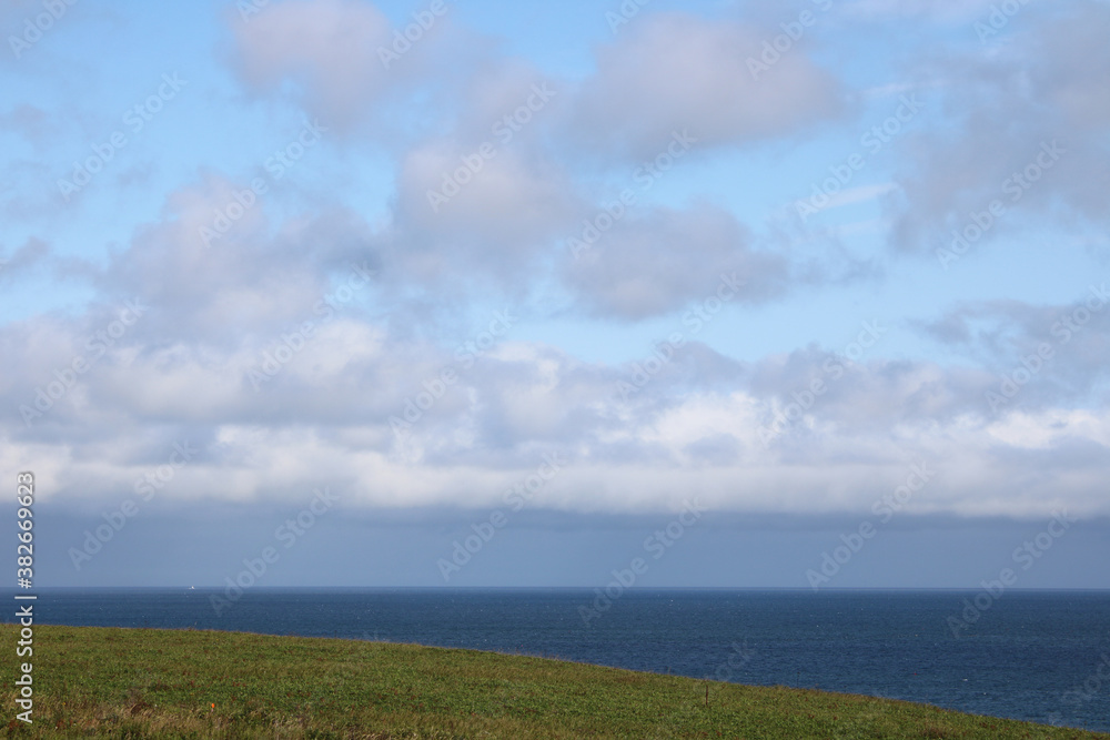 Coastal view of  clouds, meadows and Pacific Ocean (Nemuro, Hokkaido, Japan)