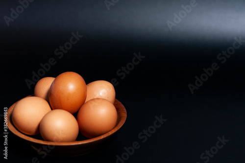 Chicken eggs in a Cup in the lower left corner of the frame.