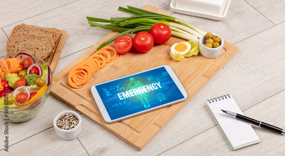EMERGENCY concept in tablet with fruits, top view EMERGENCY concept in tablet with fruits, top view