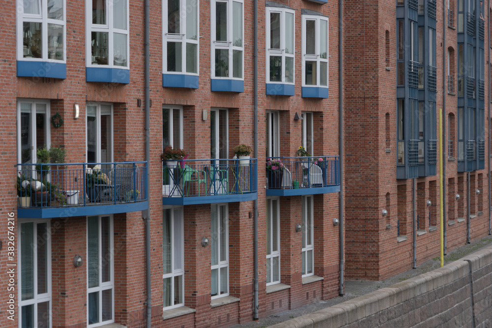 Old historic brick building with small balconies at the riverside