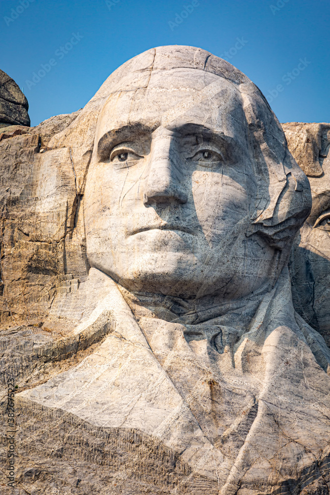 Portrait of George Washington on Mount Rushmore. Mount Rushmore National Memorial is centered on a colossal sculpture carved into the granite in the Black Hills in Keystone, South Dakota
