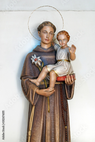 Saint Anthony holds a child of Jesus, a statue in the parish church of Saint Anthony of Padua in Zagreb, Croatia photo