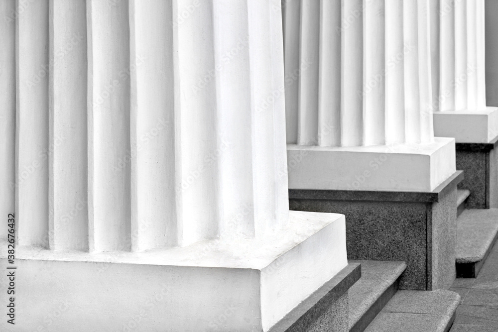 Fototapeta premium Three classical black and white Greek columns in a row
