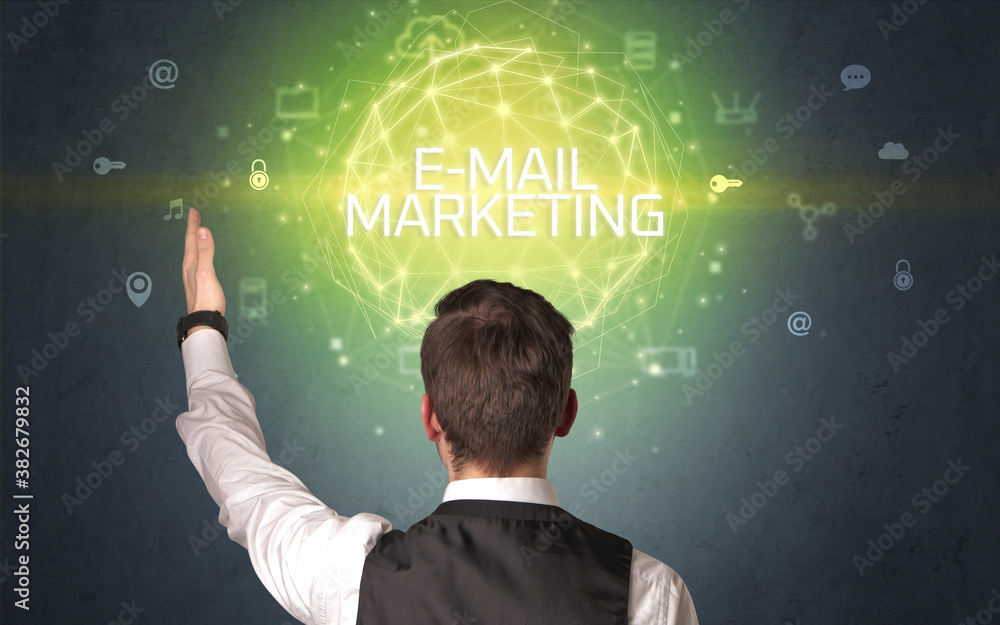 Rear view of a businessman with E-MAIL MARKETING inscription, online security concept Rear view of a businessman with E-MAIL MARKETING inscription, online security concept