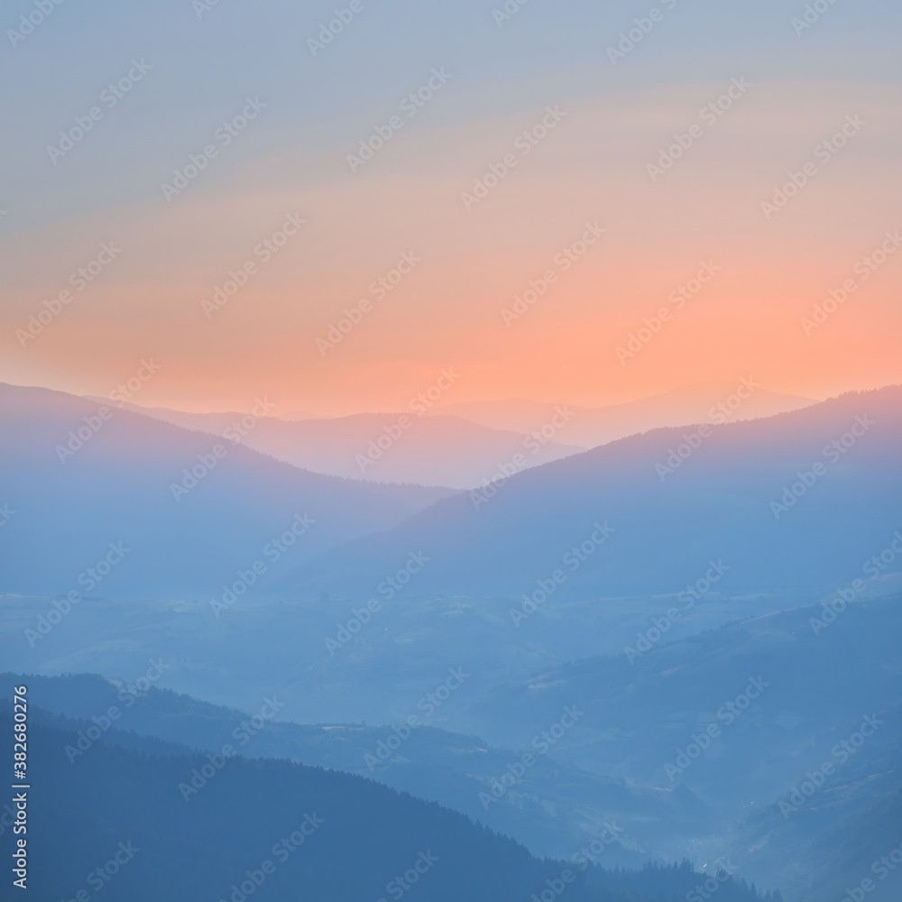 mountain chain silhouette in a blue mist before a dawn, early morning mountain background